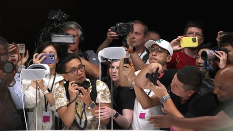 Members of the media inspect the new Apple Vision Pro headset