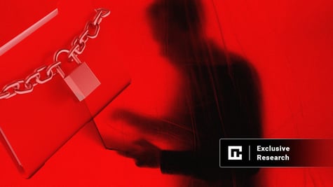 chain lock on a laptop and a shadow of a man with a laptop in the background