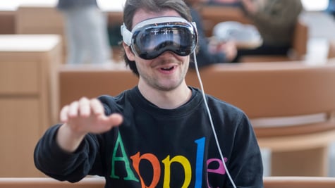 Man wears Apple augmented/virtual reality headset in Apple sweat shirt