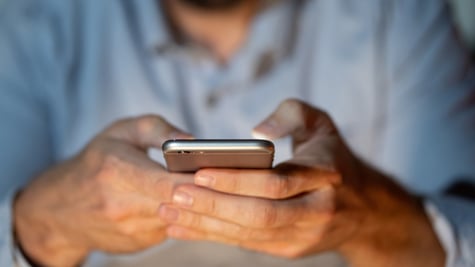 zoom in male hands operating smartphone