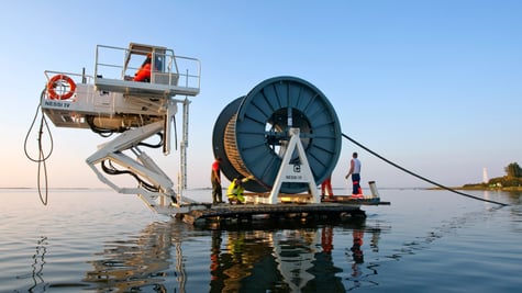 workers laying undersea cable