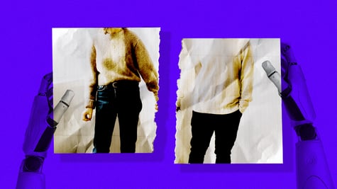 A robot holding up a ripped picture of a couple.