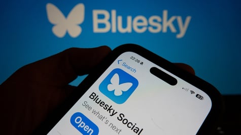 bluesky_app_hand_holding_phone