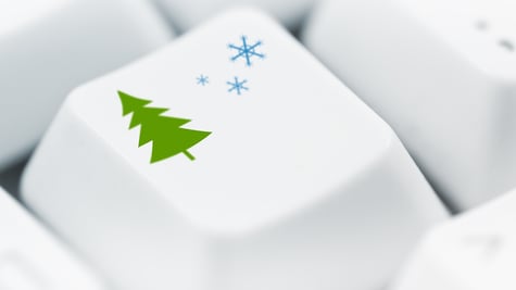 Christmas tree and snowflakes printed on white computer keyboard