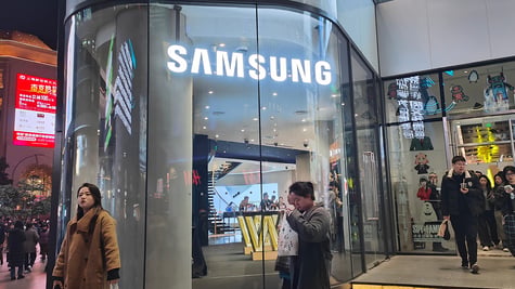 Pedestrians pass Samsung Electronics on Nanjing Road in Shanghai, China