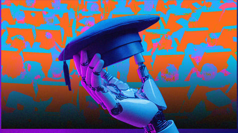 A robot holding a graduate's hat in an auditorium.