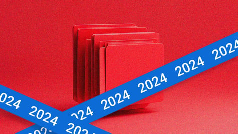 A pile of red files, with a blue tape reading 2024