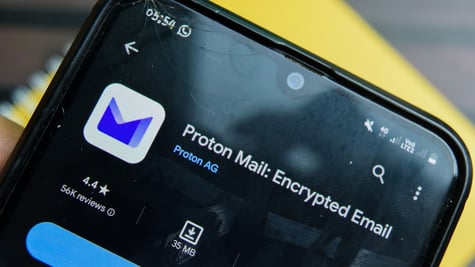 Proton logo seen through shattered smartphone glass