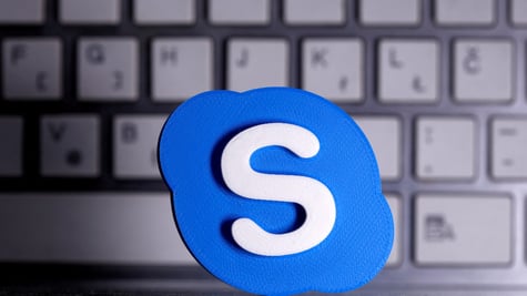 Skype logo against a keyboard in the background