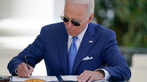 Joe Biden signing a document.