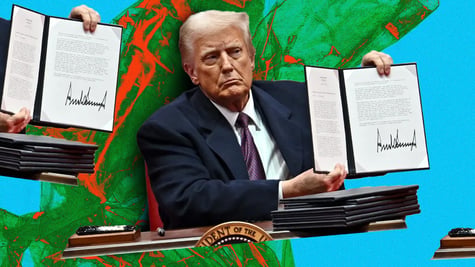 US President Donald Trump holding a signed executive order