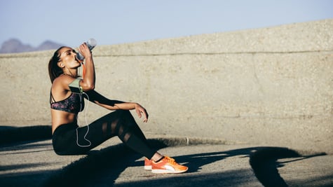 Athlete sitting and drinking water