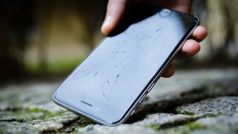 Broken iPhone on the ground