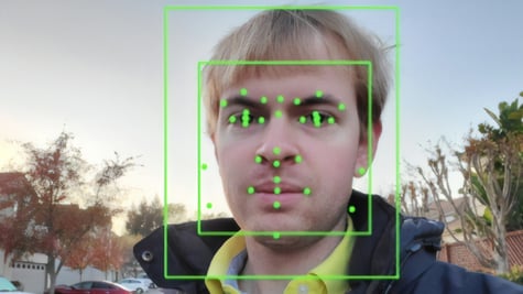A man getting his face scanned by AI.