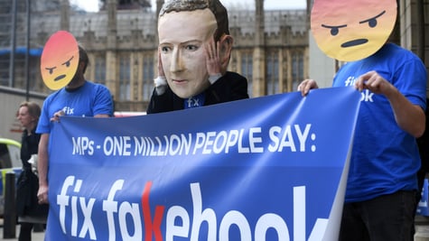 Protestors against Facebook, wearing Mark Zuckerberg and angry face masks.