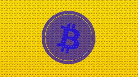 Bitcoin cryptocurrency logo superimposed on Lego brick pattern background