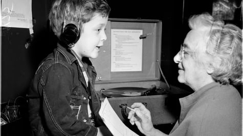 A retro pic of a medical practitioner helping a child hear successfully.