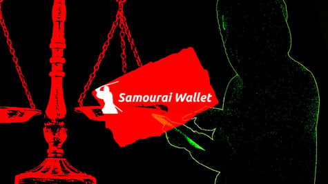 hacker holding samourai wallet logo on scale