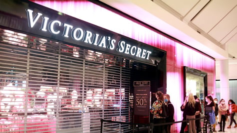 Victorias secret store about to open, pink light, people in line