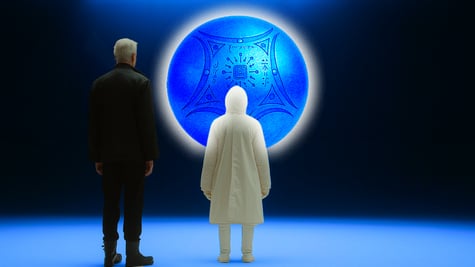 Observers looking at an orb in a gallery.