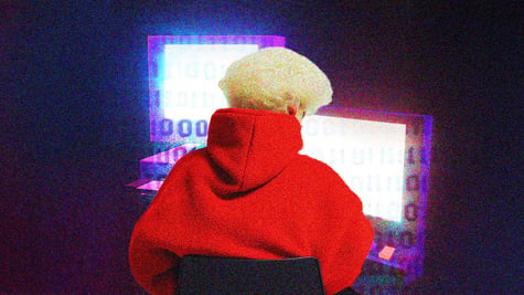 blonde hacker on a laptop with red jumper