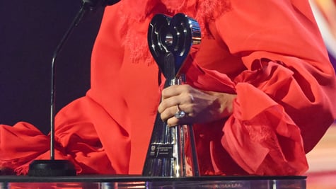 Lady Gaga holds an iHeartRadio award