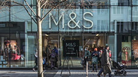 m&s store, big front sign, people on the street, a tree