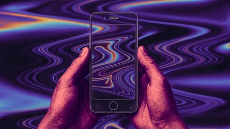 A pair of hands holding a transparent phone.