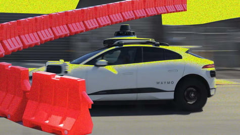 A Waymo self-driving car; road barriers