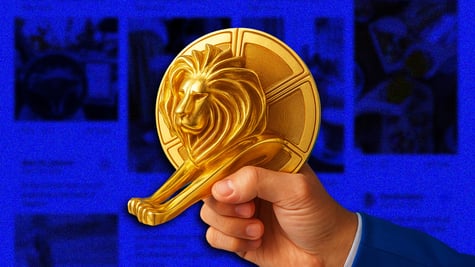 A Cannes golden lion atop a blurred social feed.