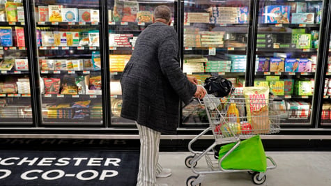 Co-op store inside, black man, fridge, frozen food, pizza, cart