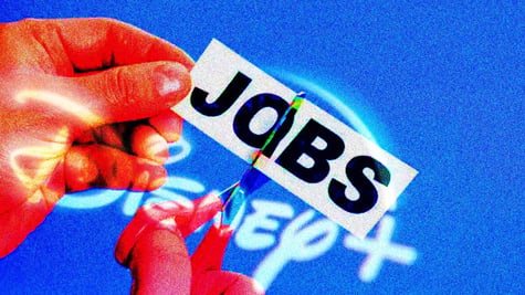 A hand cutting a piece of paper that says "Jobs" superimposed on Disney logo