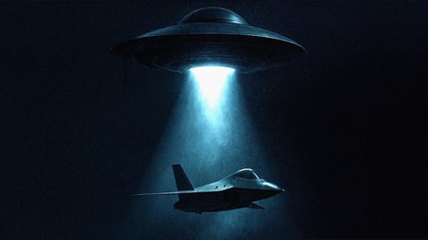 A UFO flying in the dark above a stealth bomber.
