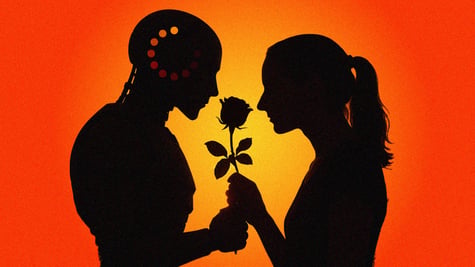 A couple smelling a flower.