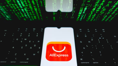 aliexpress app app open on phone, on black laptop and green numbers