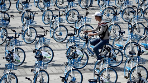 china, blue hello bikes, one cyclist, white hat