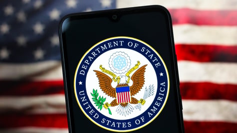 department of state logo, eagle in centre, us flag in the back, phone screen
