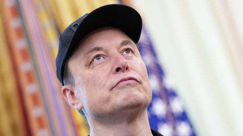 elon muskss face with black hat, looking up with blurry flads in the back