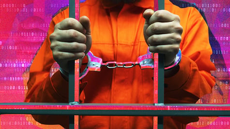 Handcuffed man behind the bars in jail; criminal; cybercriminal