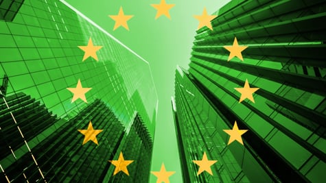 EU flag yellow stars in circle over a city, buildings in green