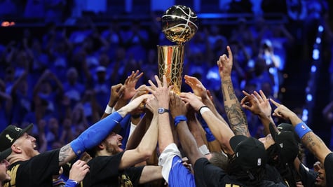men holding golden trophy