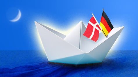 white origami ship in water with danish and german slags, young moon in corner