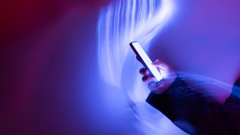 phone in had surrounded with wave of blue light
