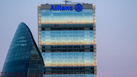 Allianz blue sign on top of glass building, blue sky