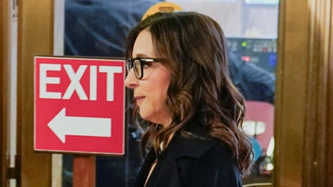 Linda Yaccarino next to exit sign