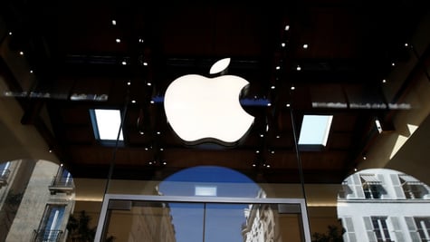 white shiny apple logo surrounded  by dark glass