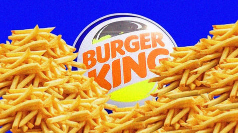The Burger King logo surrounded by mounds of french fries.