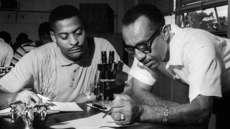 A black and white photo of professors in the lab.