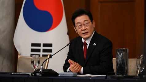 south korean president in black suit and white shirt