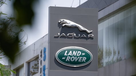 jaguar silver logo and sign, Land Rover logo in green circle